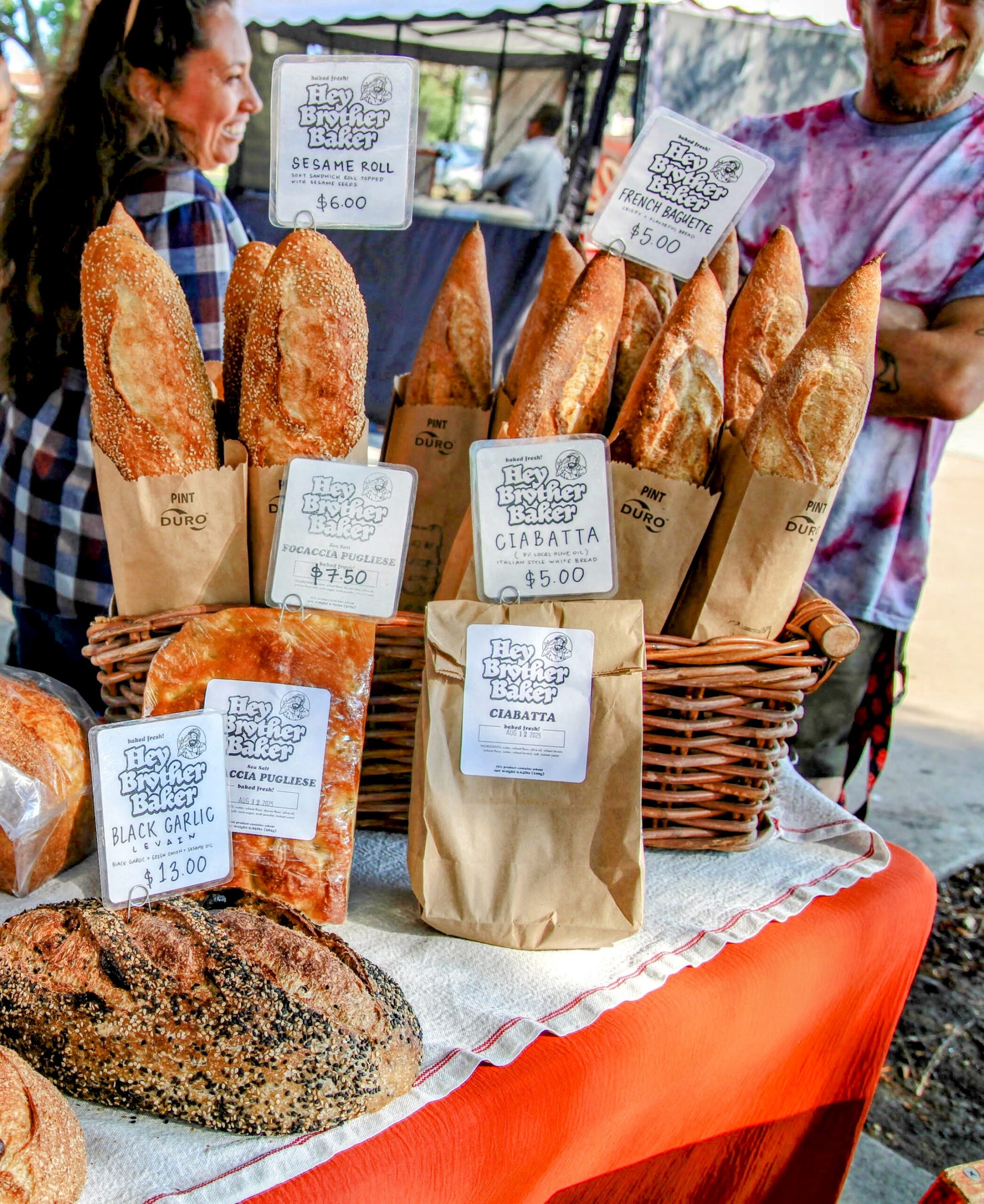 Baguettes and ciabatta bread in paper bags and a basket