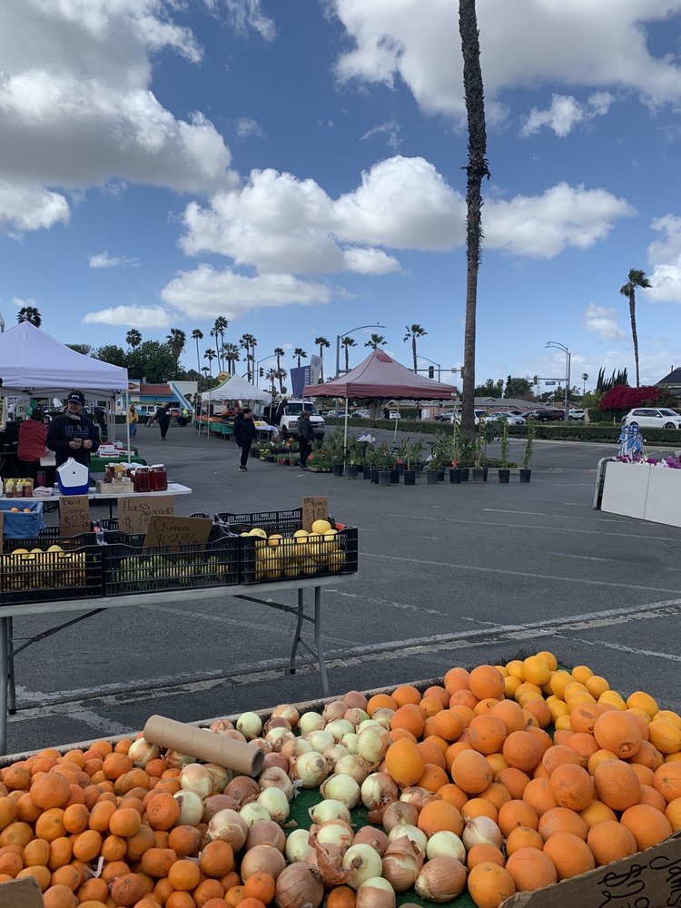 Oranges, onions, produce, and market tents at Buena Park