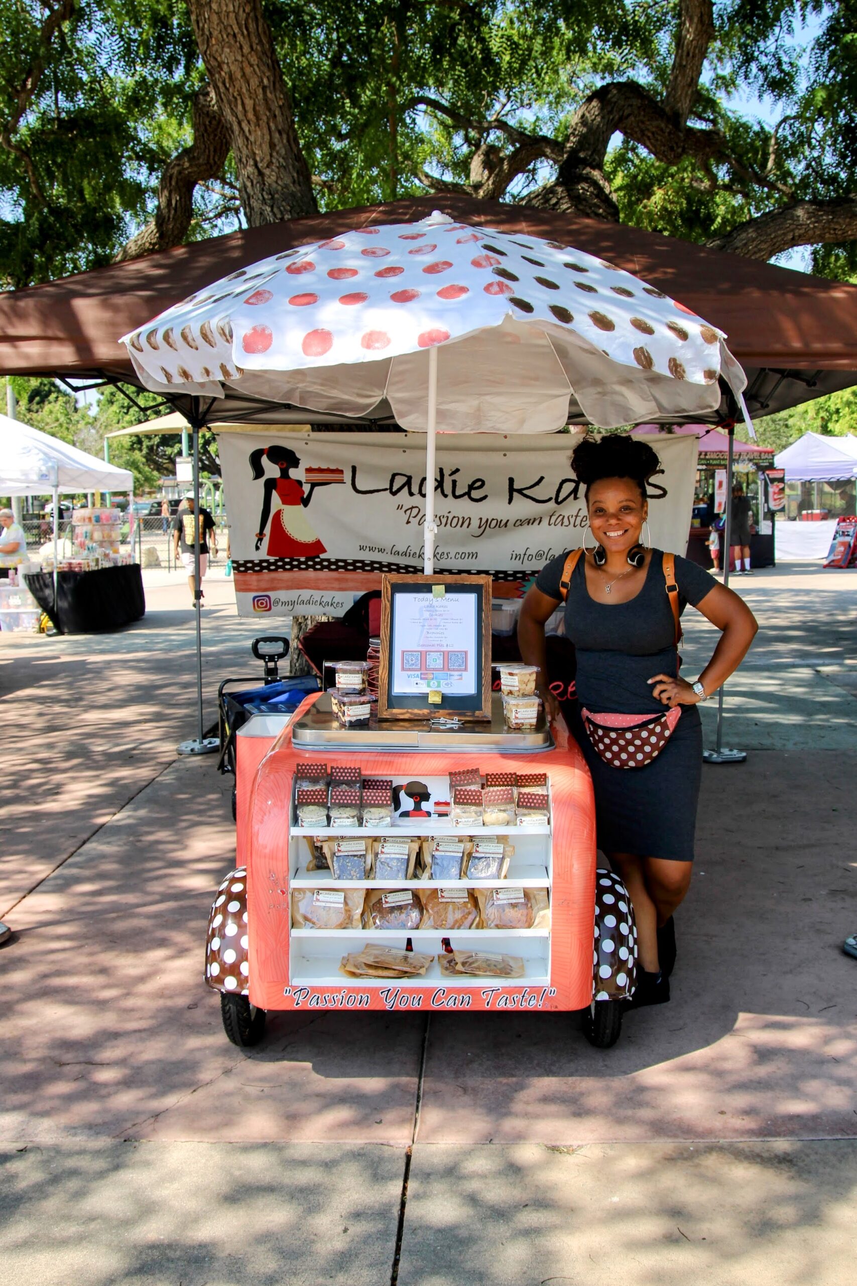 Dessert booth with umbrella at a farmers market