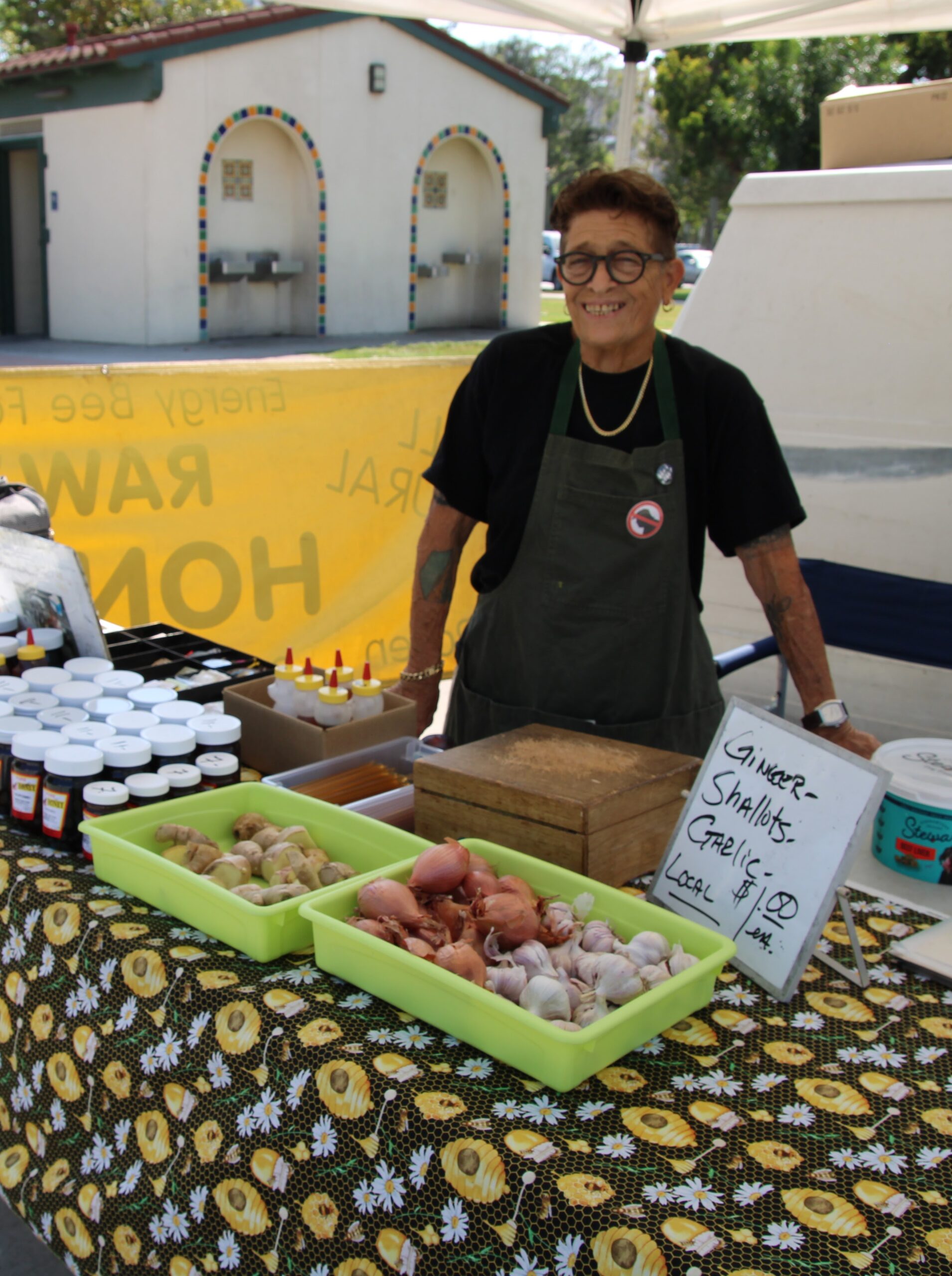 Garlic, shallots, and ginger at a farmers market vendor table