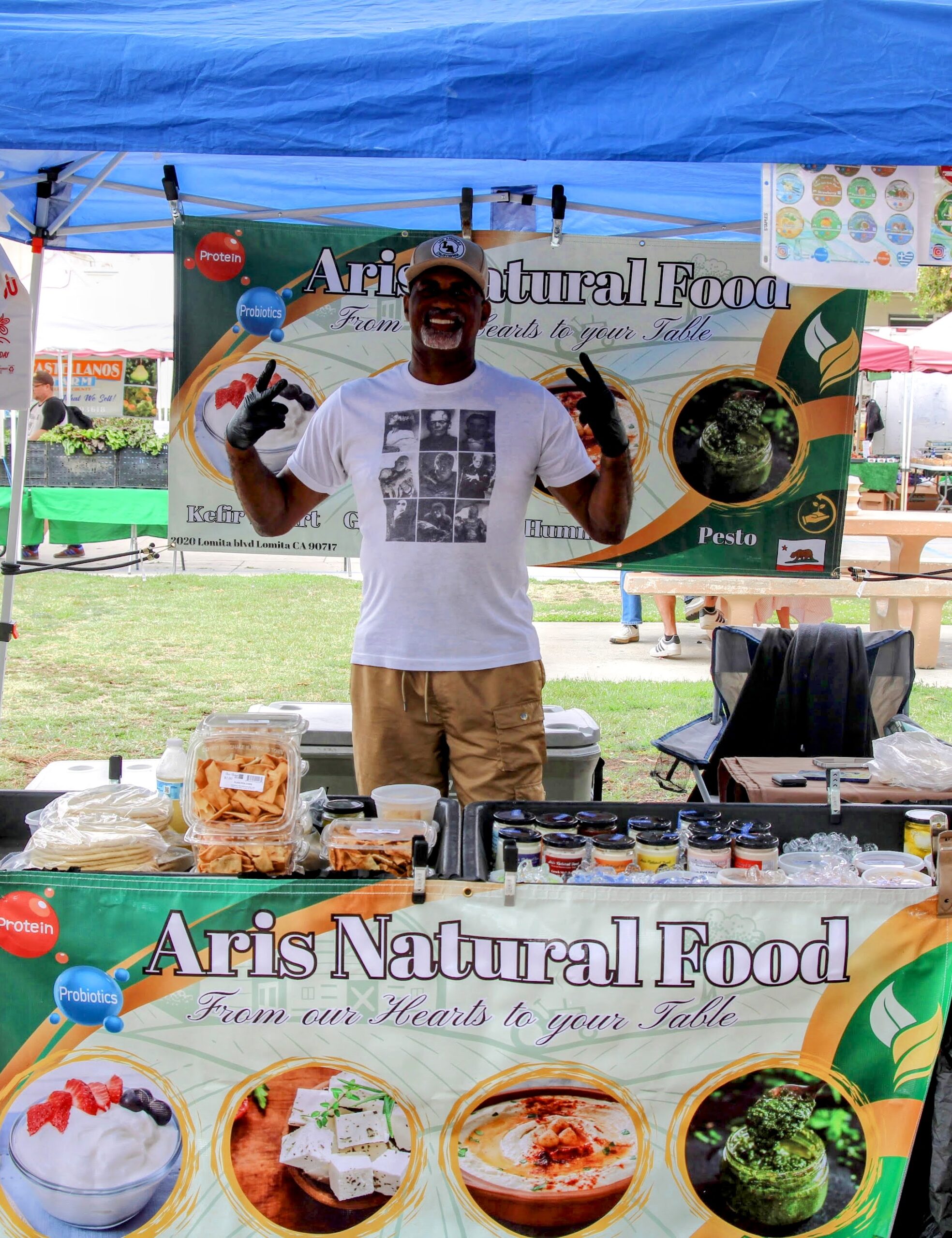 Natural food vendor tent and stall at a Local Harvest Farmers Market