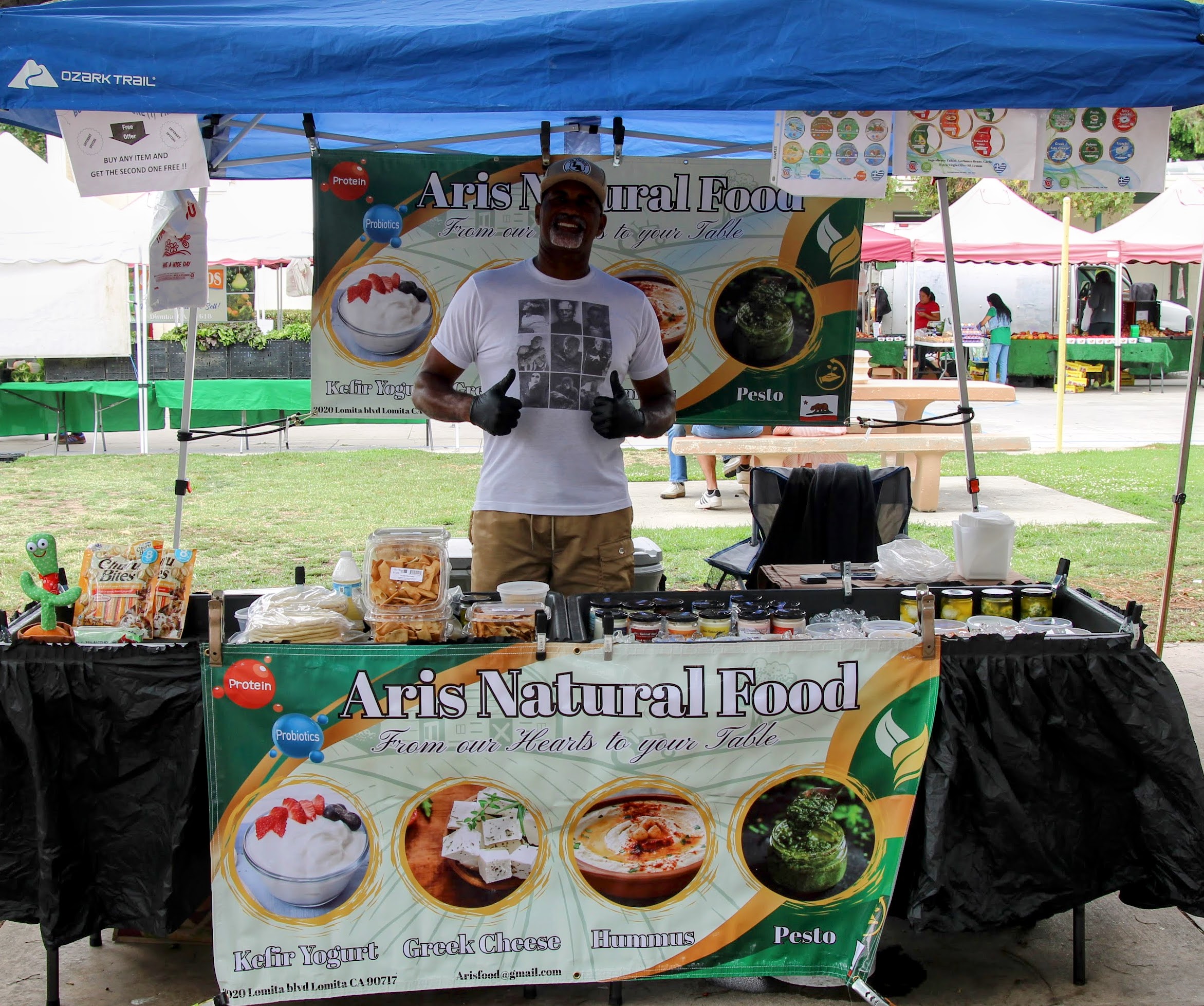Natural food vendor tent and stall at a Local Harvest Farmers Market