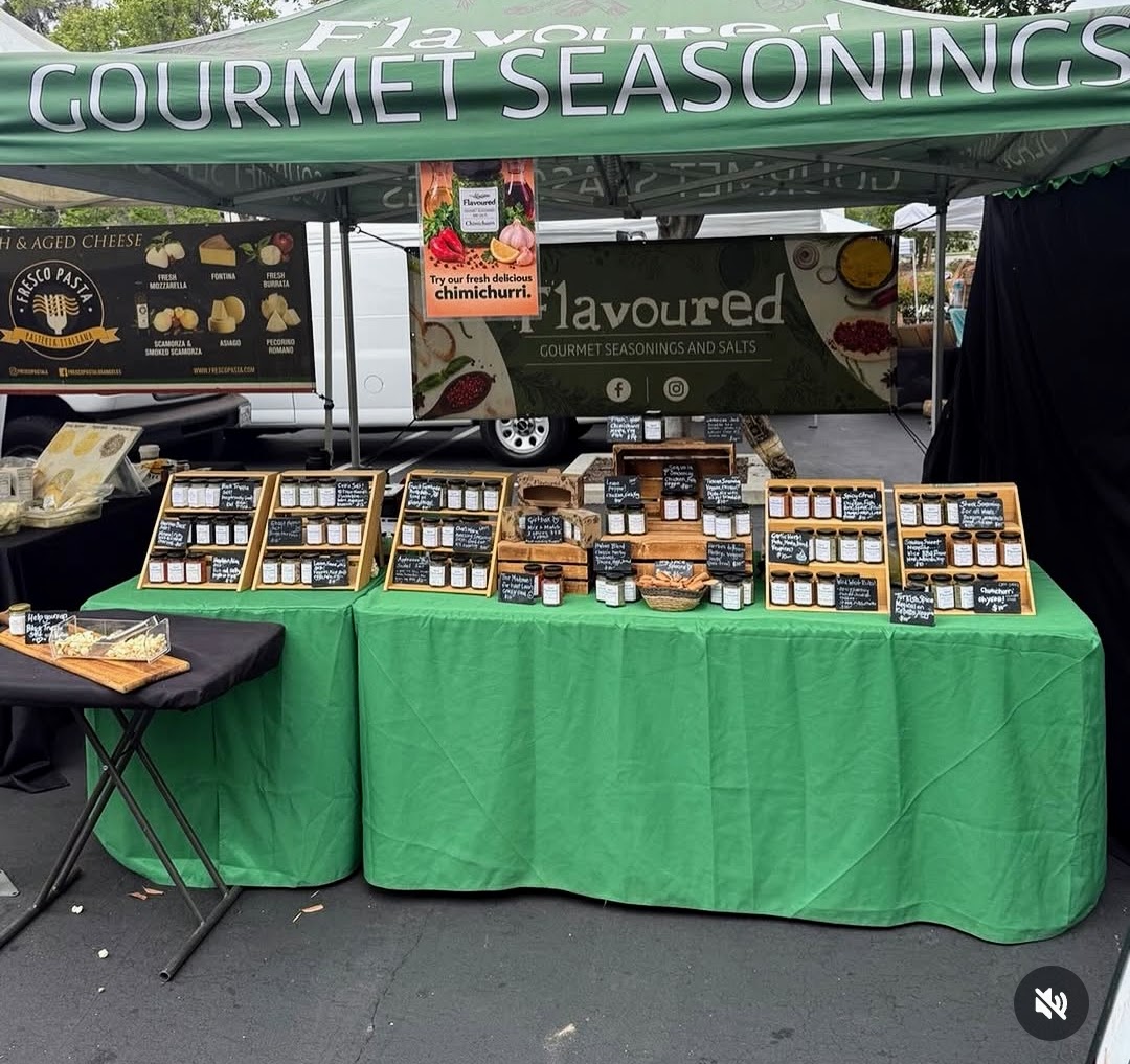 Gourmet seasonings and spice jars at a farmers market stall