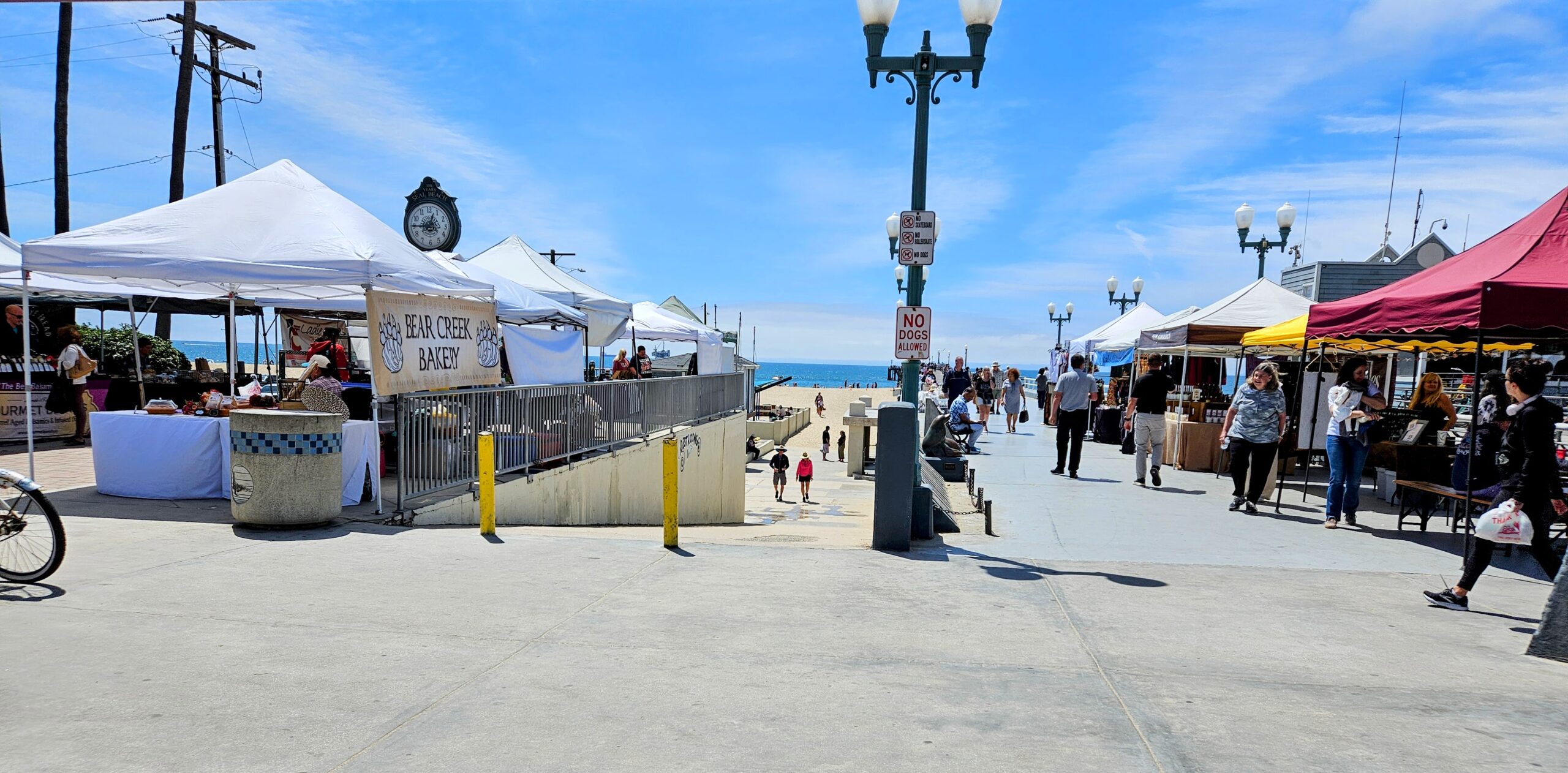 Farmers market tents near Seal Beach Pier and the Pacific Ocean